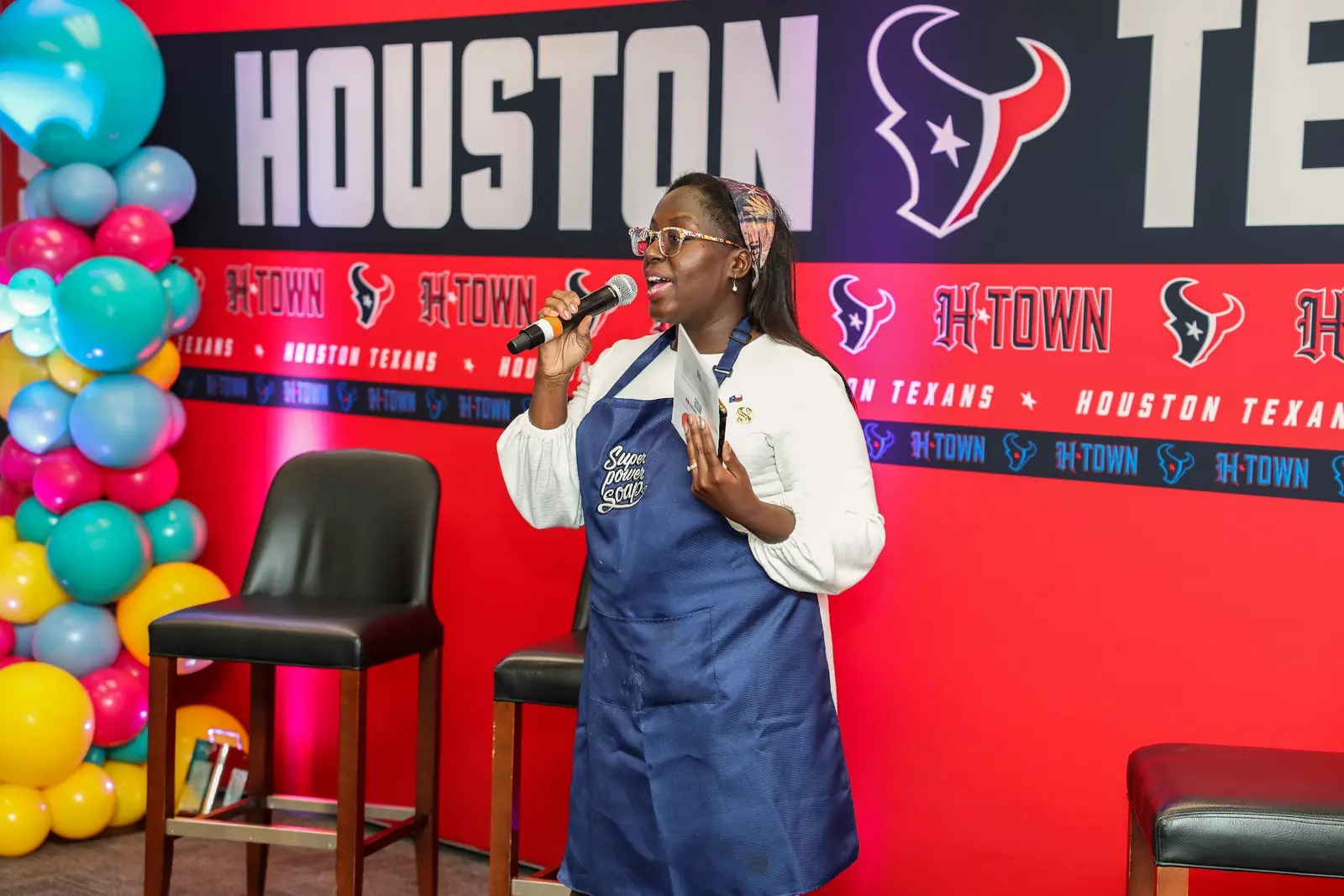 Evidence Image: The facilitator you meet during planning is the person who leads the room. Priscilla M. Mensah speaking at a Houston Texans Foundation soapmaking event