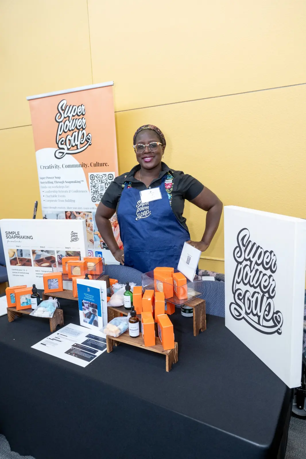 Super Power Soap founder with a branded soap display in Houston