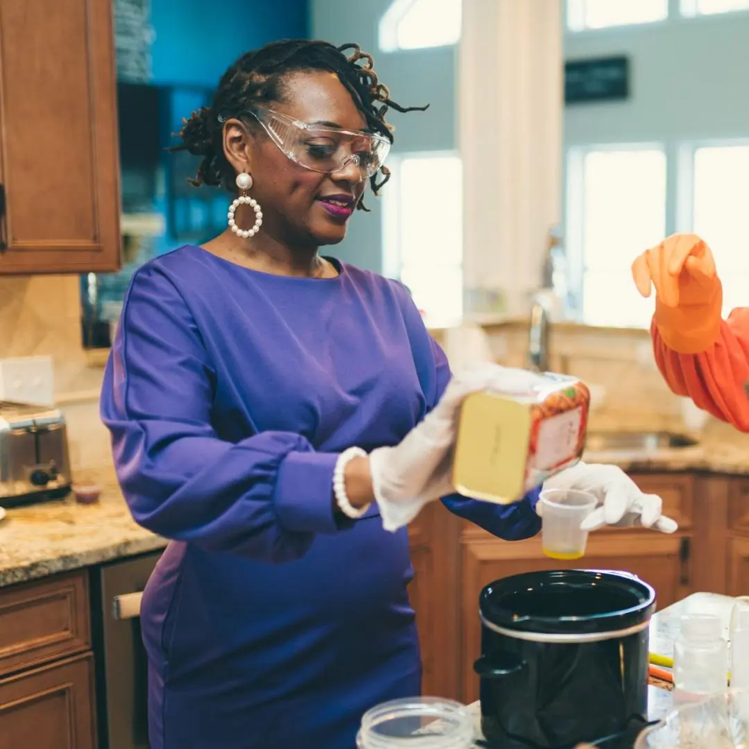 Evidence Image: Measurements and sequence are made visible instead of left abstract. Soapmaking instructor measuring oil during a hands-on class demonstration